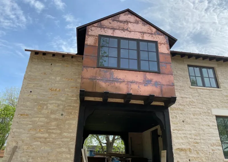 Copper metal panel facade on a stone building for Skylight Installation in East Troy