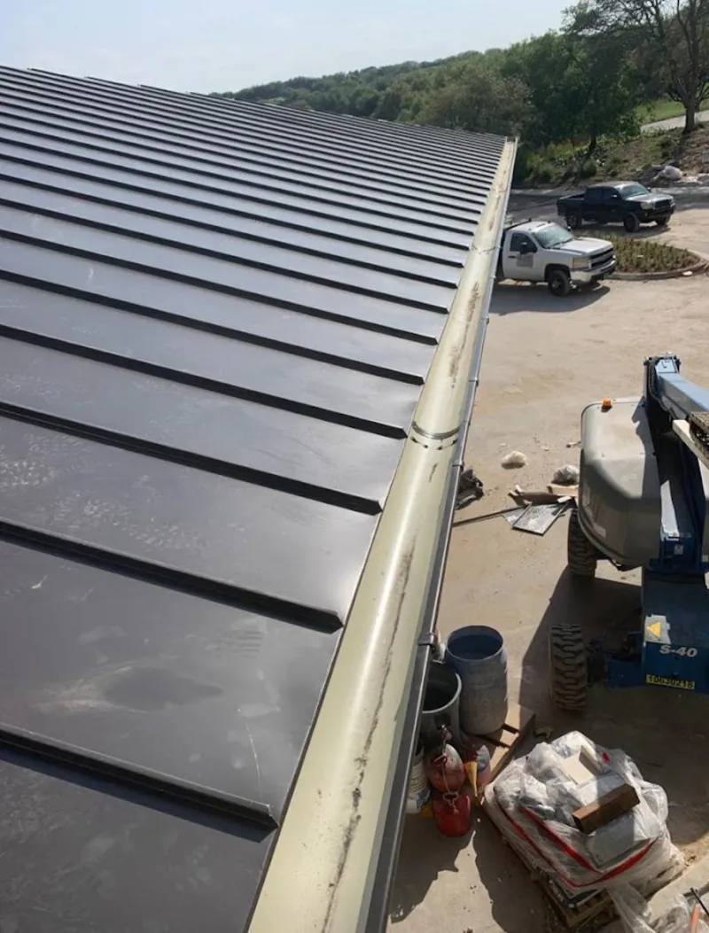Standing seam panel and gutter detail on a metal roofing jobsite in East Troy